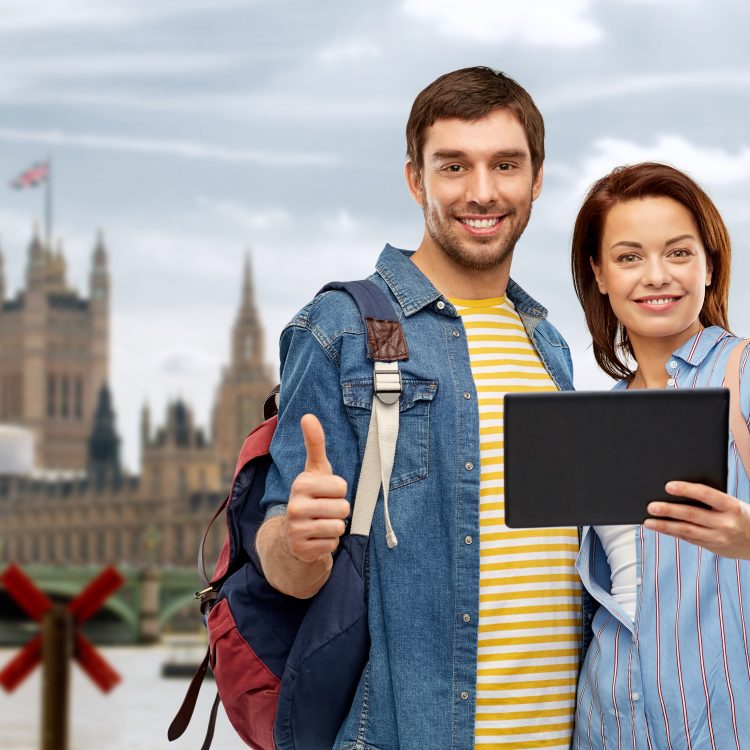 couple of tourists with tablet computer in london